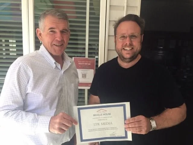Scott Nelson receiving a Certificate of Appreciation from Braille House on behalf of TPR Media
