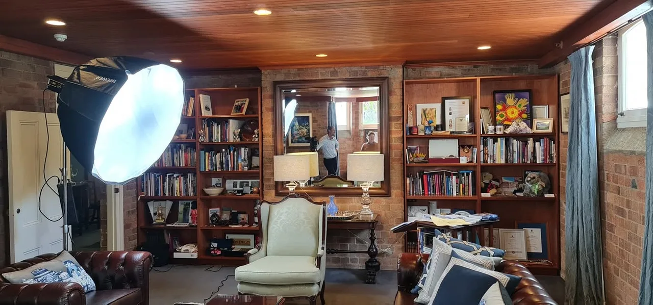 Production lighting set up in a book-lined room at Government House