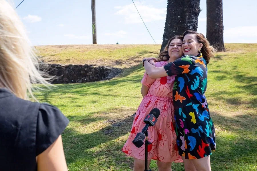 Natalie Abbott and Stefanie Jones on camera beside the beachfront during the Coolangatta production