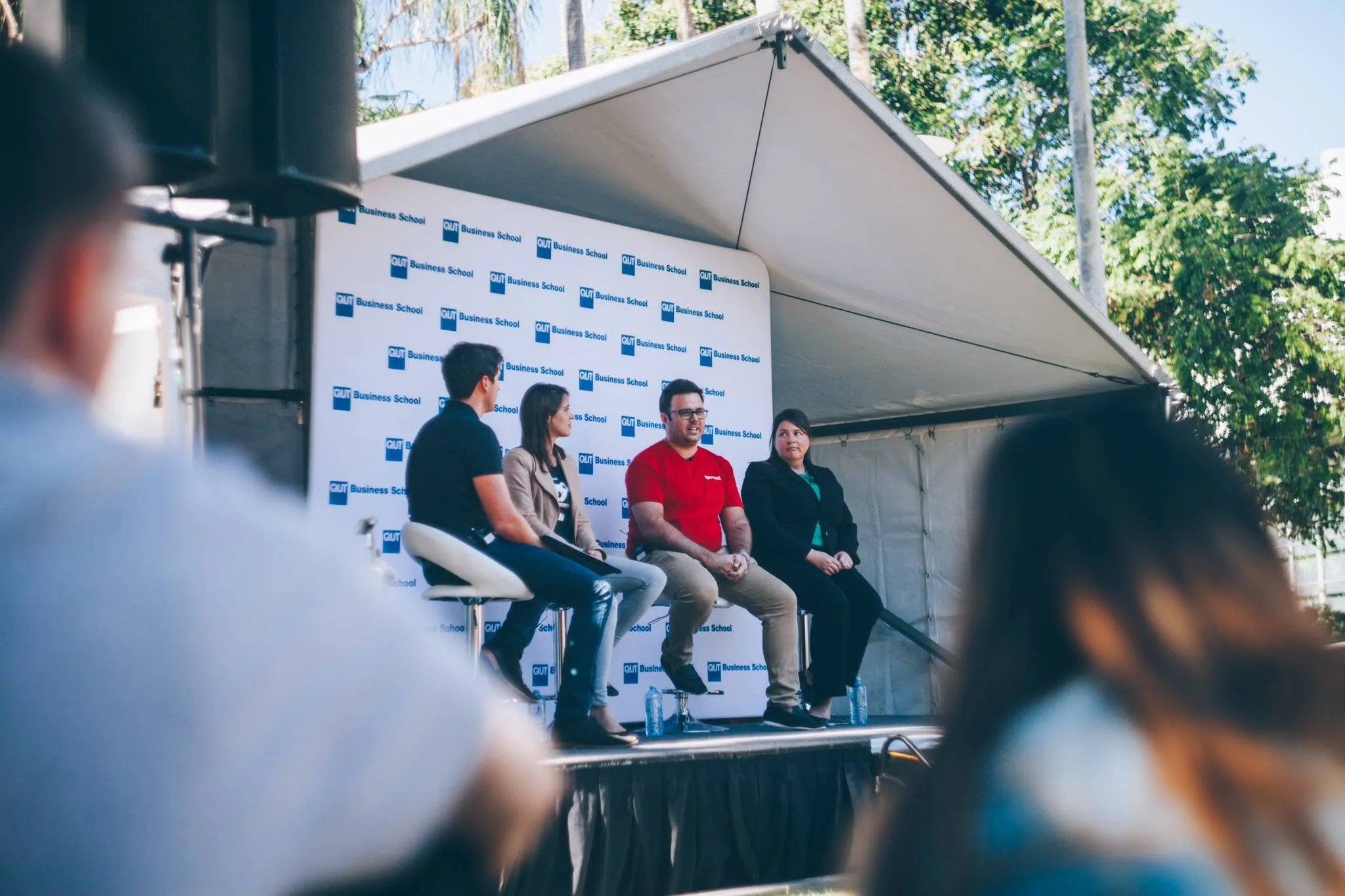 The audience's view of Tim Nelson and fellow panellists on the QUT Business School stage