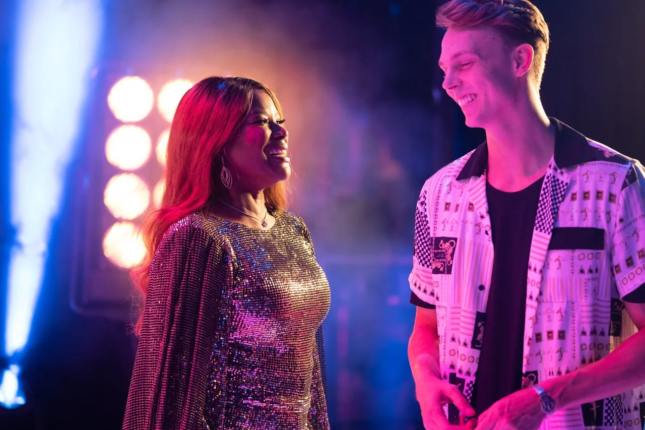Marcia Hines alongside another performer under colourful lighting during Saturday Night Fever at QPAC