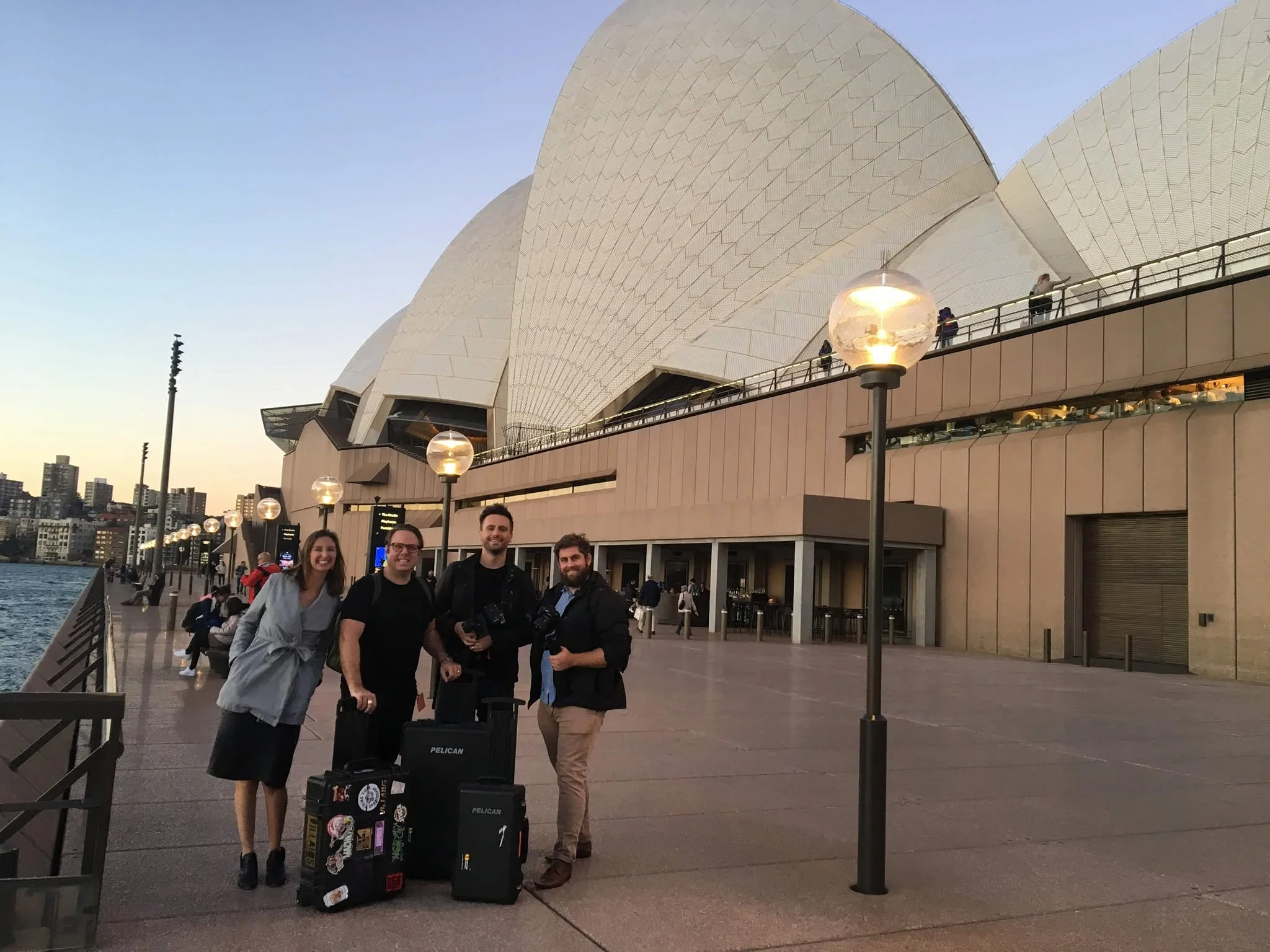 TPR Media's filming team with cameras and production equipment outside the Sydney Opera House during the West Side Story opening trip